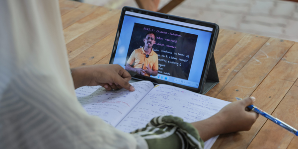 Student studying on laptop in library