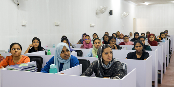Student studying on laptop in library