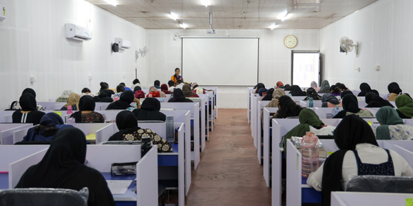 Student studying on laptop in library